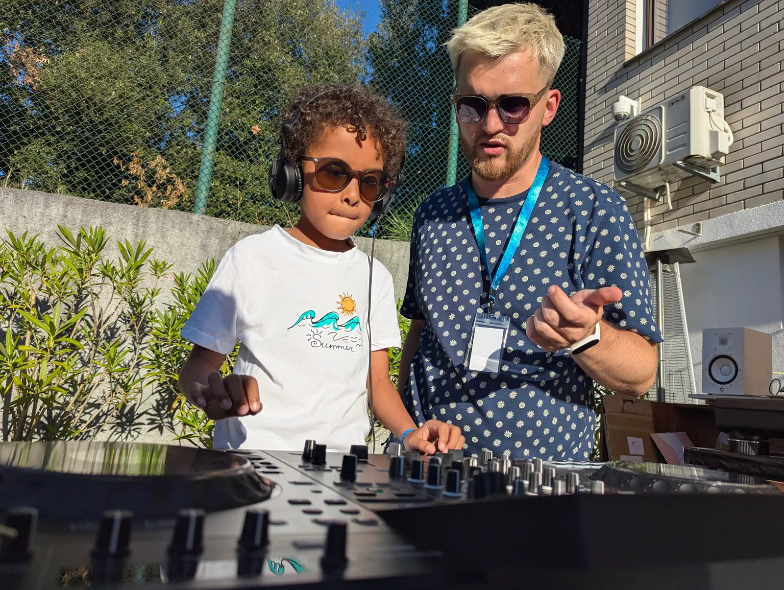 A young student learning to DJ next to an instructor at Stereo Paradise